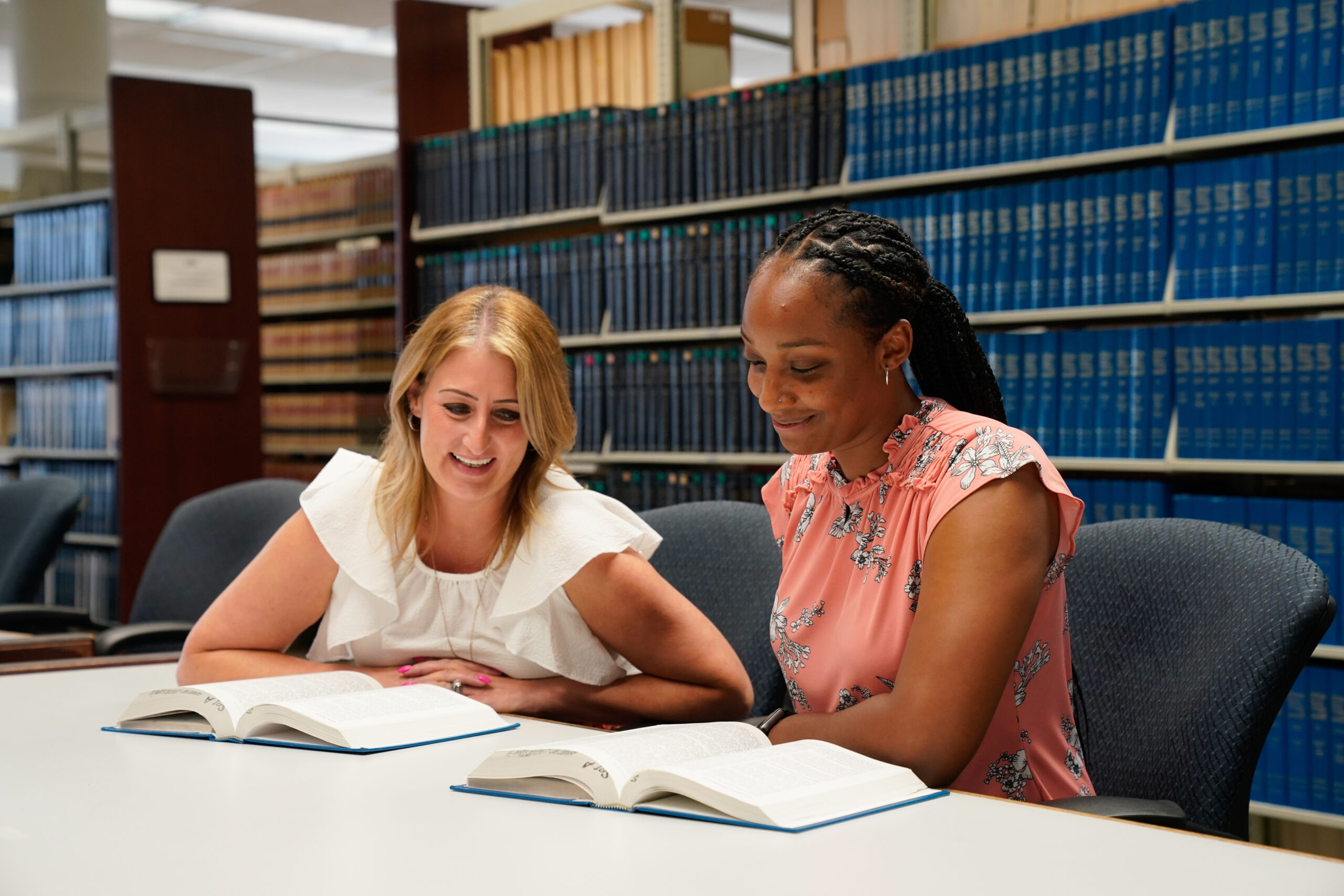 Image of two law students in the law library.