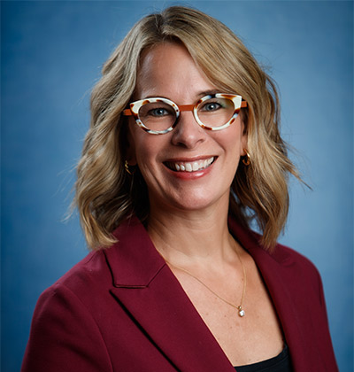 Professional portrait of Melissa Shultz in red jacket